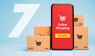 Crecimiento de las compras online y mobile shopping Teléfono móvil con pantalla de compra en línea rodeado de cajas de cartón