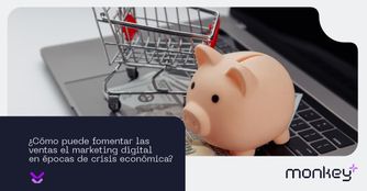 Cómo puede fomentar las ventas el marketing digital en épocas de crisis económica Alcancía de cerdito y carrito de compras sobre teclado de laptop representando economía